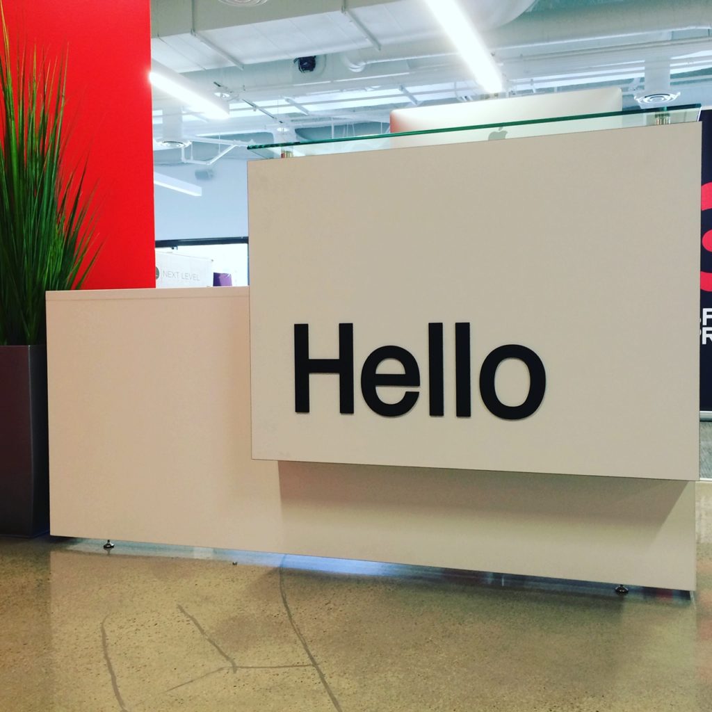 this lobby desk with a pleasant Hello message for incoming clients
