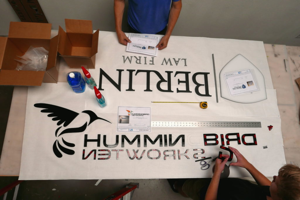 the crew making lobby signs in the production area